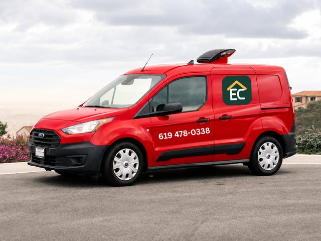 Red service van displaying the EC logo and contact phone number