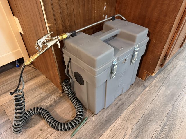 Portable equipment case with a hose and application wand